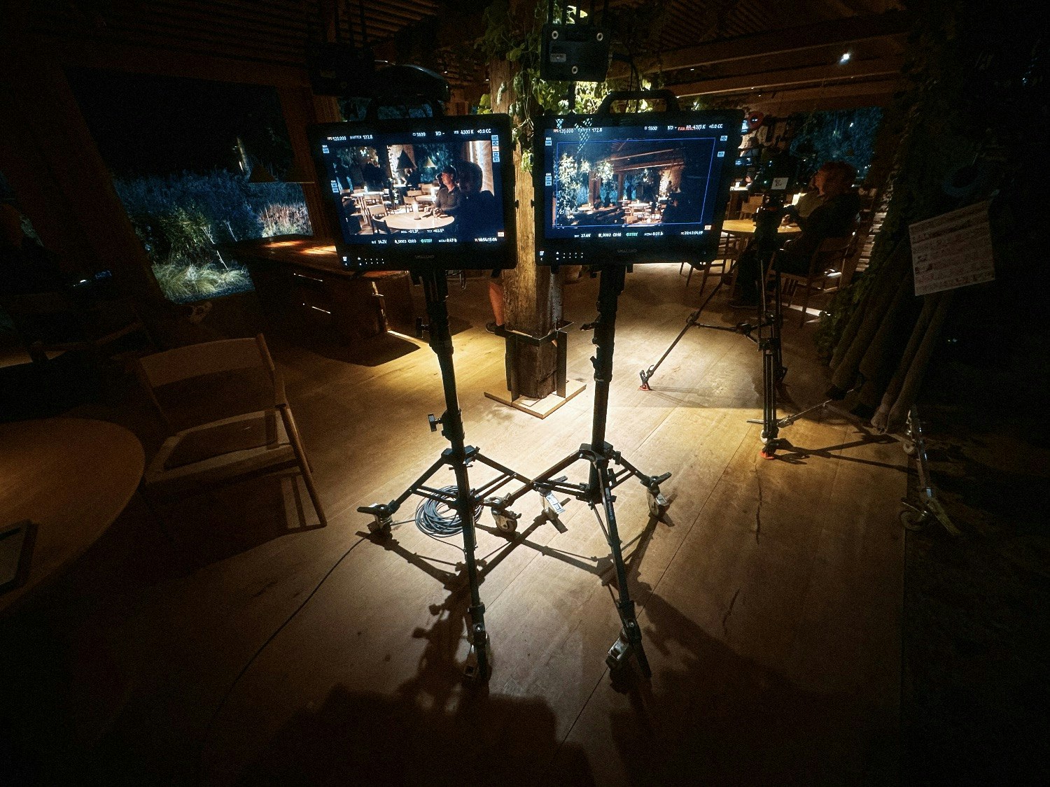 Production workstation with twin monitors and stage lights on a Wise Media film shoot